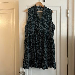 Mirol knee-length green polka-dotted dress.